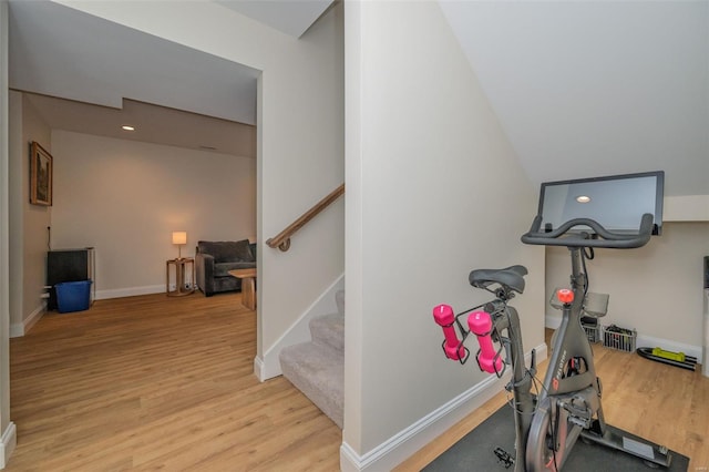 workout area with baseboards and light wood-type flooring