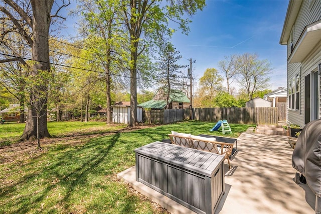view of yard with a patio, a fenced backyard, and a jacuzzi