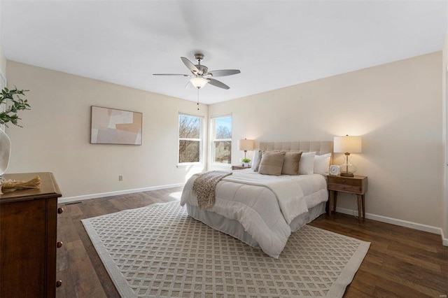 bedroom with a ceiling fan, wood finished floors, and baseboards