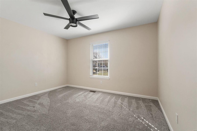 empty room with visible vents, baseboards, carpet floors, and ceiling fan