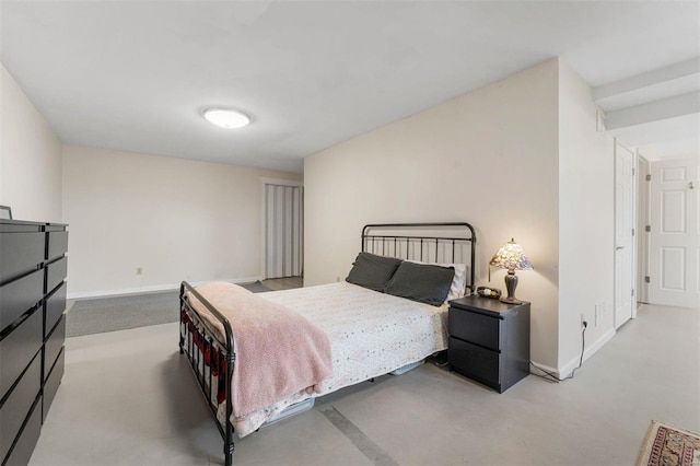 bedroom with baseboards and concrete flooring