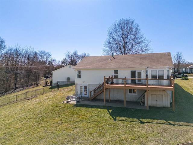 back of property with french doors, a yard, a wooden deck, and a patio area