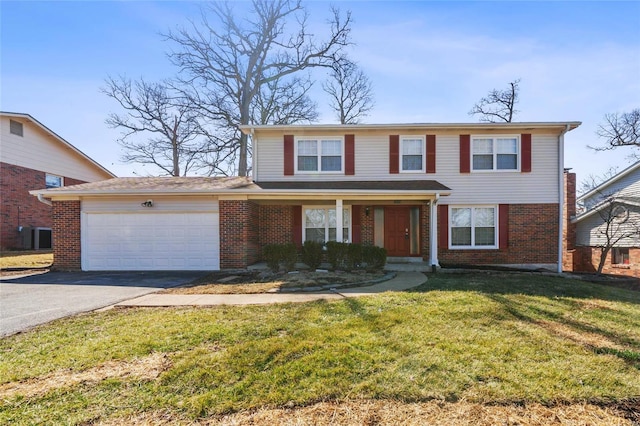 traditional-style house with aphalt driveway, brick siding, an attached garage, and a front lawn