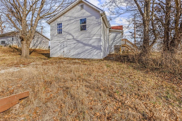 view of side of home with stairway