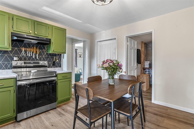 dining room with baseboards and light wood finished floors