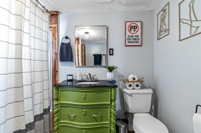 bathroom featuring toilet and vanity