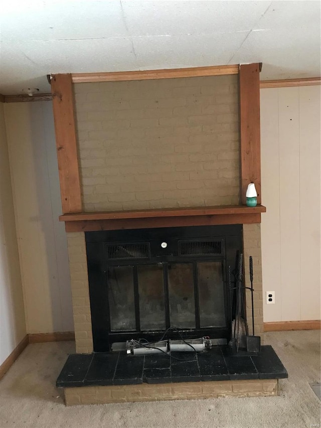 room details featuring carpet floors, a brick fireplace, and baseboards