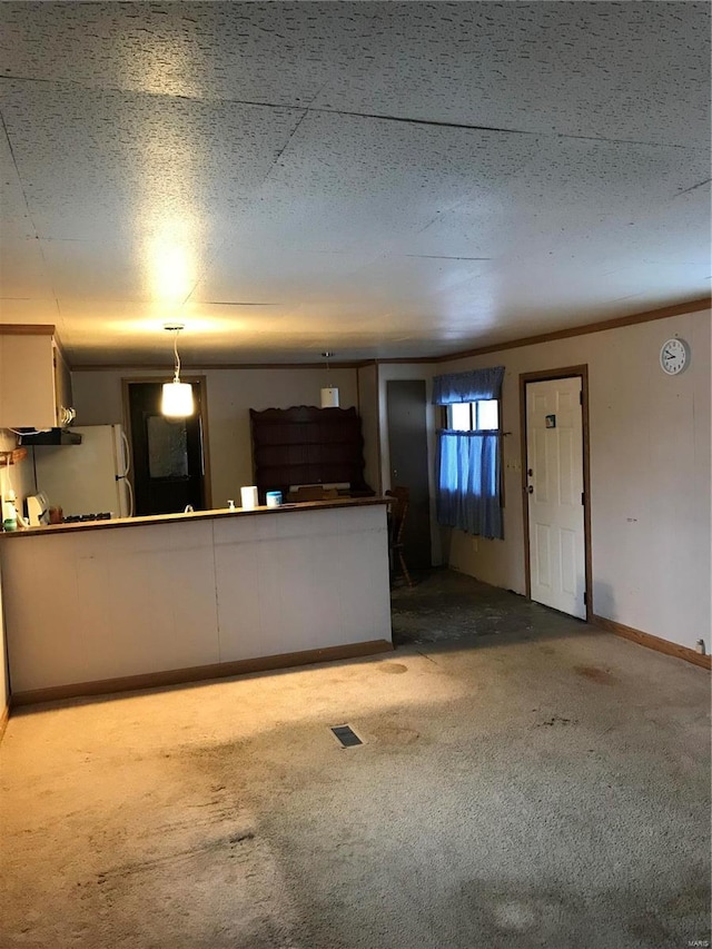 unfurnished living room with light carpet, baseboards, visible vents, ornamental molding, and a textured ceiling