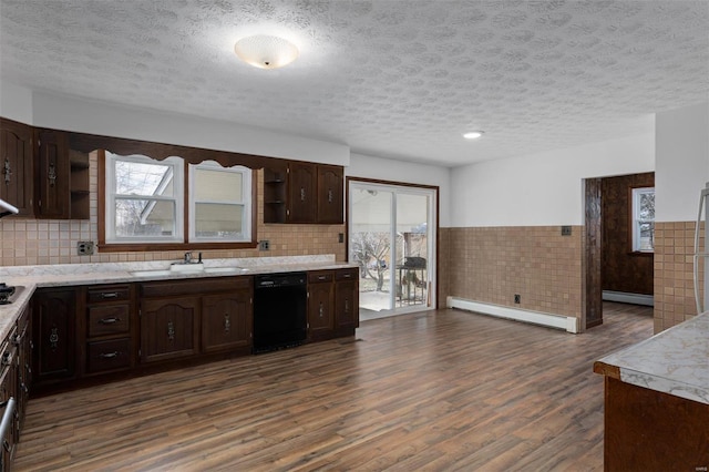 kitchen featuring black dishwasher, wainscoting, dark brown cabinets, a baseboard heating unit, and open shelves