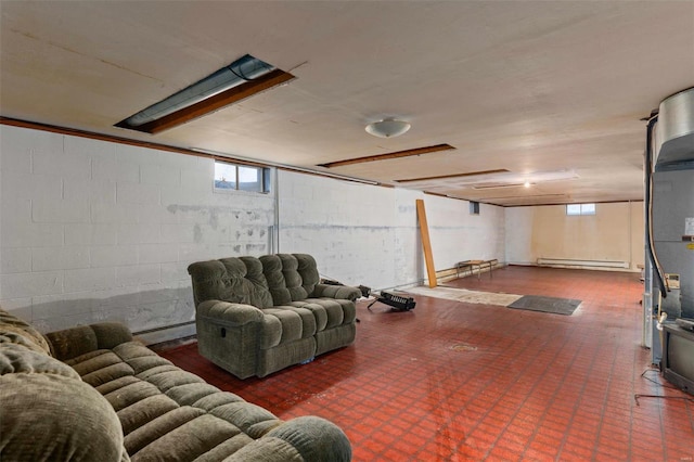 below grade area with a baseboard heating unit, baseboard heating, concrete block wall, and tile patterned floors