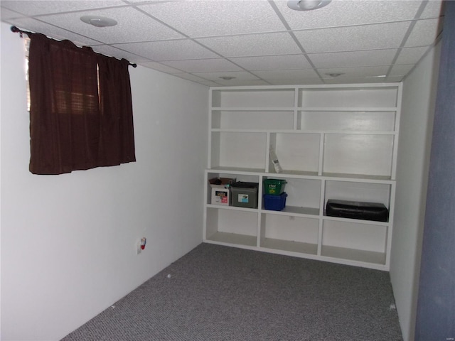 carpeted empty room featuring a paneled ceiling