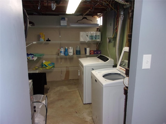 clothes washing area featuring laundry area, washing machine and dryer, and electric panel