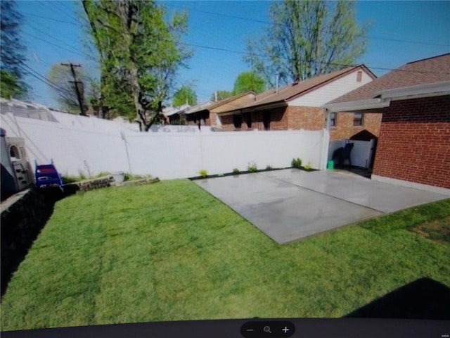 view of yard featuring a patio area and a fenced backyard