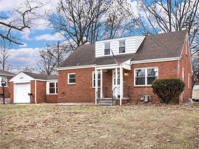 view of front of house with brick siding, an attached garage, and a shingled roof