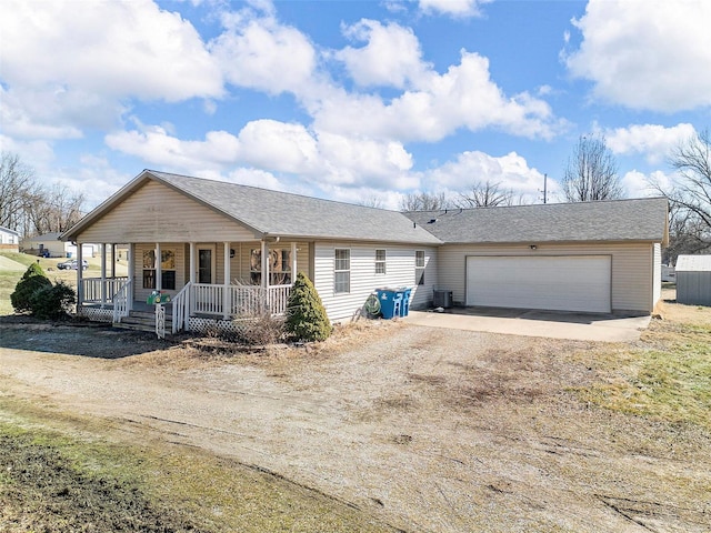 ranch-style house featuring dirt driveway, a porch, an attached garage, and cooling unit