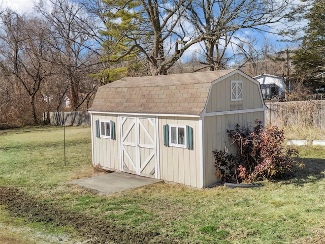 view of shed featuring fence