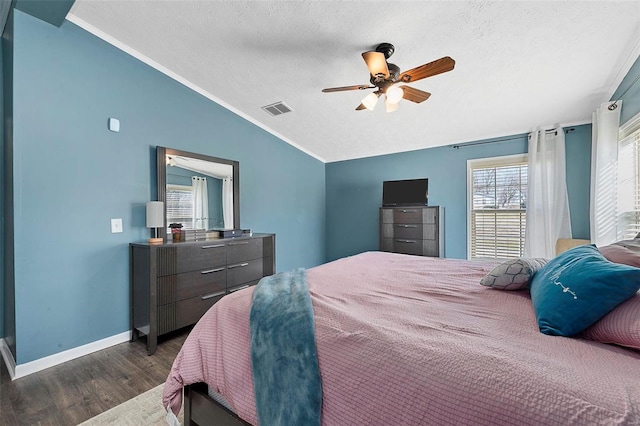 bedroom featuring lofted ceiling, dark wood-style flooring, visible vents, and a textured ceiling