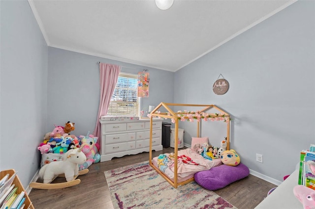 bedroom with baseboards, wood finished floors, and crown molding