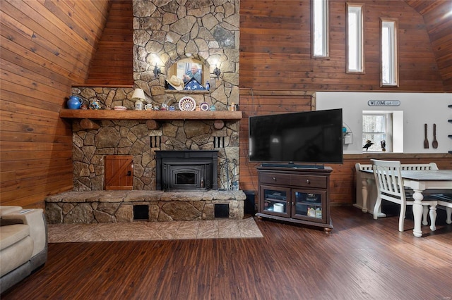 living room featuring high vaulted ceiling, wooden walls, and wood finished floors