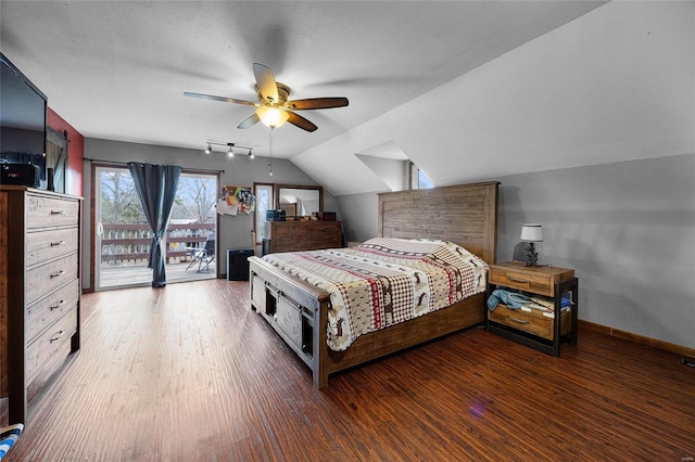 bedroom with vaulted ceiling, access to outside, wood finished floors, and baseboards