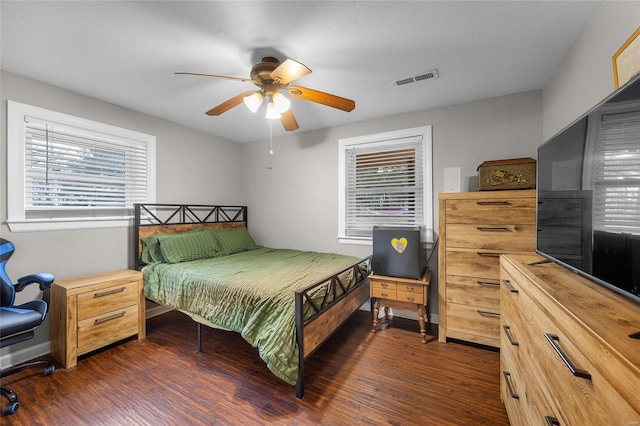 bedroom with dark wood-type flooring, visible vents, and ceiling fan