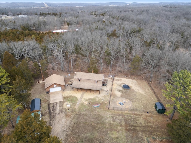 birds eye view of property featuring a view of trees