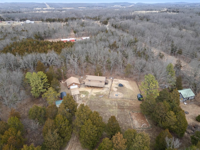 drone / aerial view with a wooded view