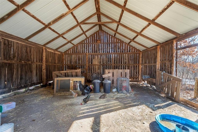 misc room with lofted ceiling and metal wall