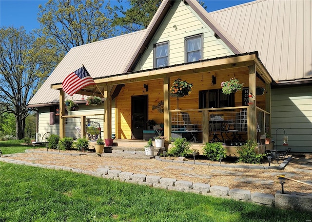 view of front facade with metal roof and a porch