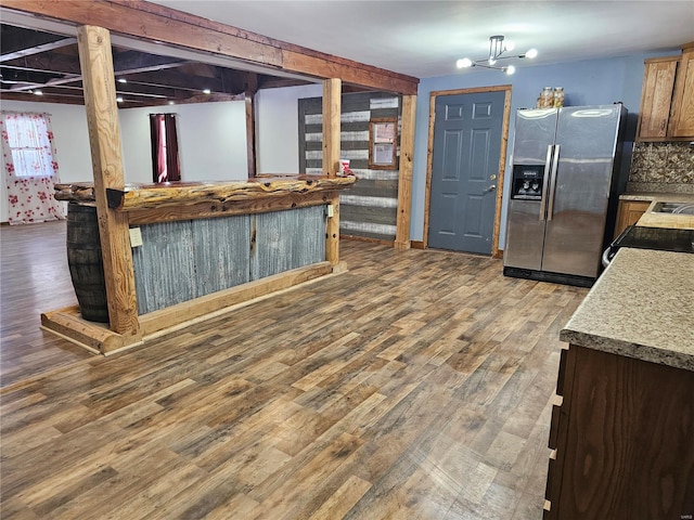 kitchen featuring tasteful backsplash, light countertops, wood finished floors, range with electric cooktop, and stainless steel fridge with ice dispenser