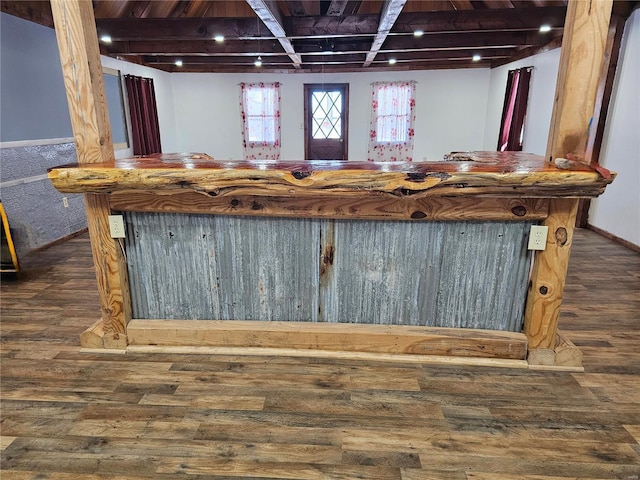 bar with a dry bar, baseboards, wood finished floors, and beamed ceiling