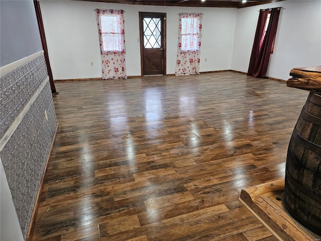 interior space featuring baseboards and wood finished floors