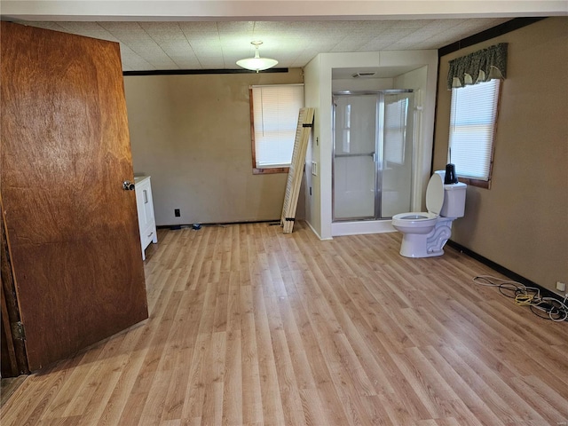 spare room featuring baseboards and light wood finished floors