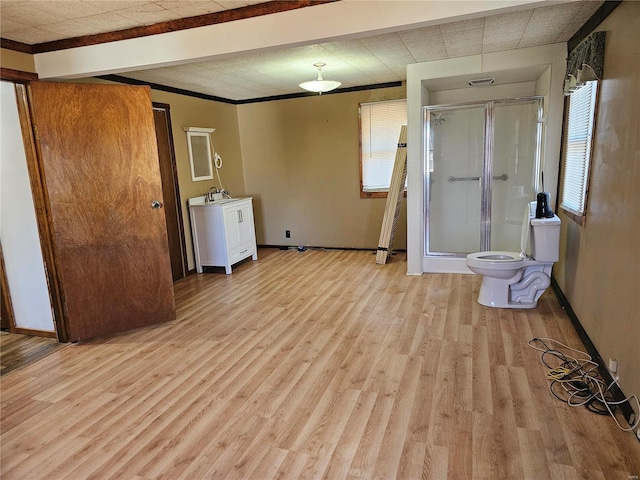 unfurnished room with crown molding, light wood-type flooring, and baseboards