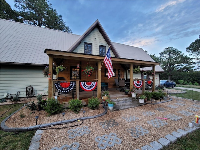 view of front of home with a porch and metal roof