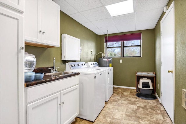 laundry room featuring gas water heater, separate washer and dryer, a sink, baseboards, and cabinet space