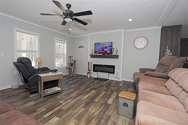 living room featuring baseboards, a glass covered fireplace, dark wood-style flooring, crown molding, and a textured ceiling