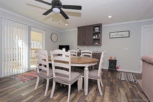 dining space featuring a textured ceiling, baseboards, dark wood-style flooring, and crown molding