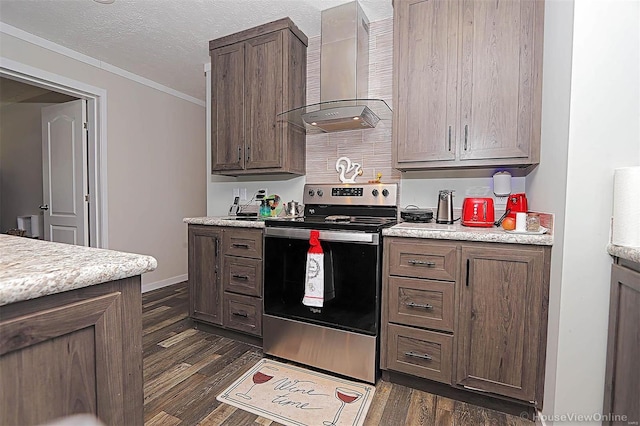 kitchen featuring stainless steel range with electric stovetop, light countertops, wall chimney range hood, and dark wood-style floors