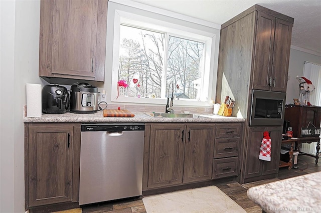 kitchen with a sink, stainless steel appliances, and light countertops