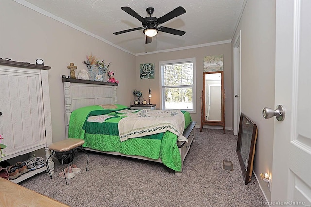 carpeted bedroom with baseboards, ceiling fan, ornamental molding, and a textured ceiling