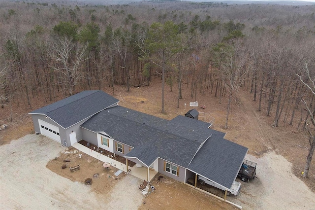 drone / aerial view featuring a forest view