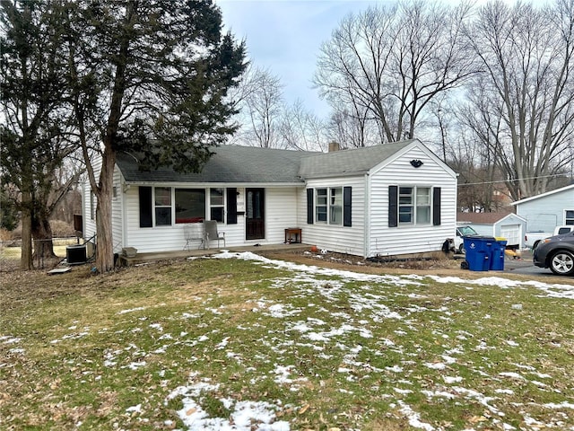 ranch-style home with a chimney, central AC, and a lawn