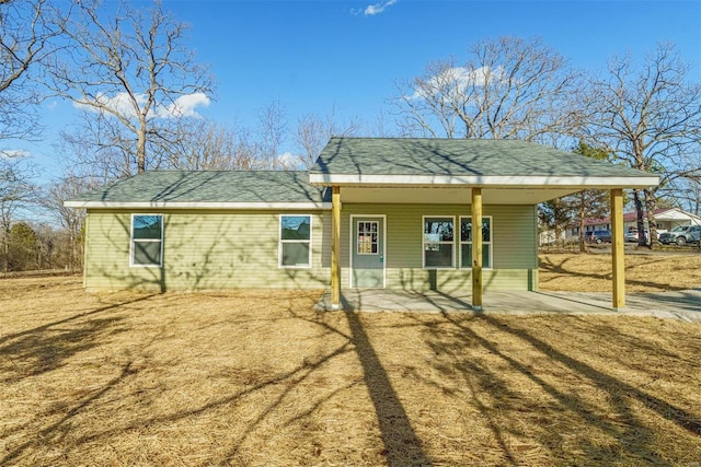 back of property with roof with shingles