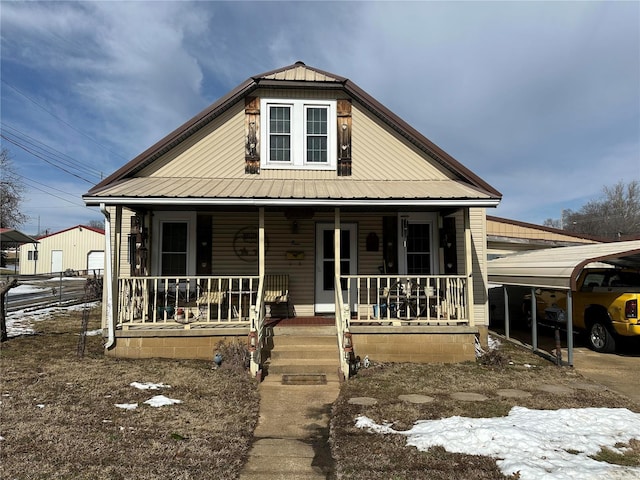 view of front of house featuring covered porch and metal roof