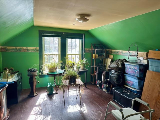 additional living space featuring dark wood-style floors and vaulted ceiling