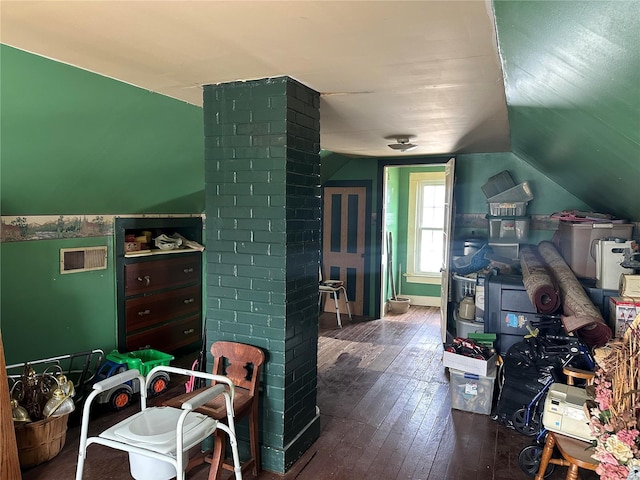 recreation room with lofted ceiling, visible vents, and wood finished floors