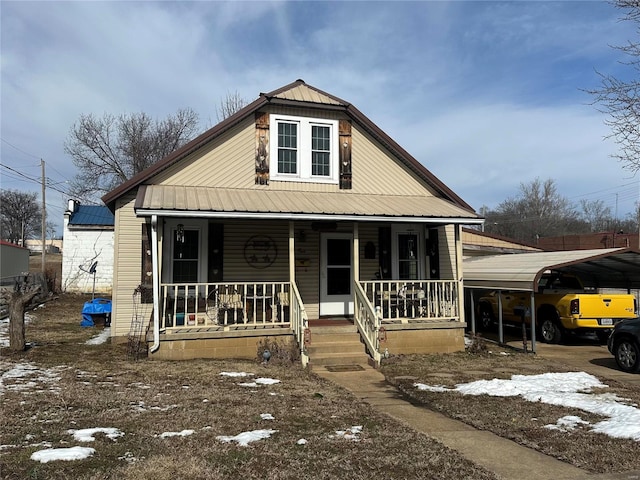 view of front of house with covered porch, metal roof, and a detached carport