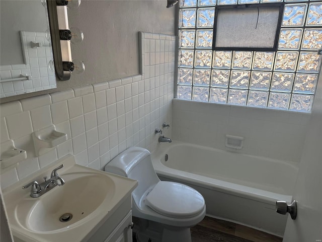 bathroom with toilet, shower / tub combination, vanity, and tile walls