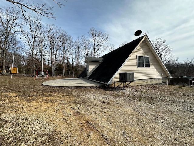 view of property exterior featuring central AC and a patio area